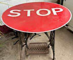 Bespoke occasional table, with cast iron Singer treadle base and enamel STOP road sign top, 72cm