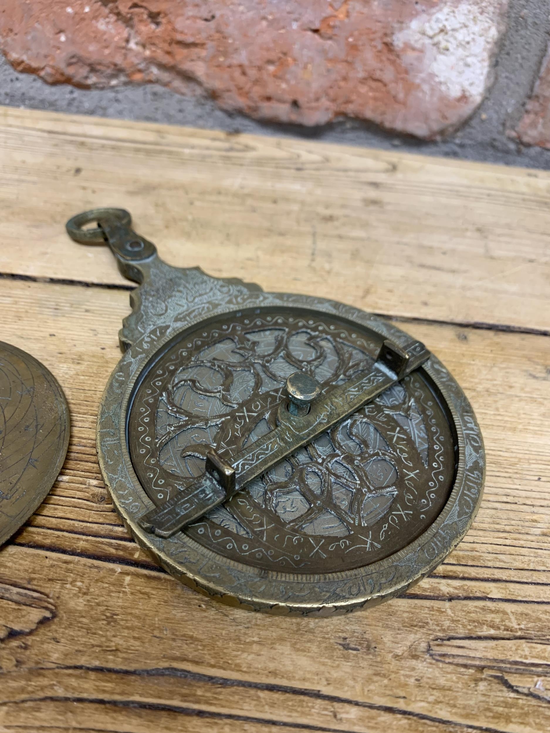 Antique Islamic brass astrolabe instrument, engraved throughout having pierced rete, four doubled - Image 2 of 4
