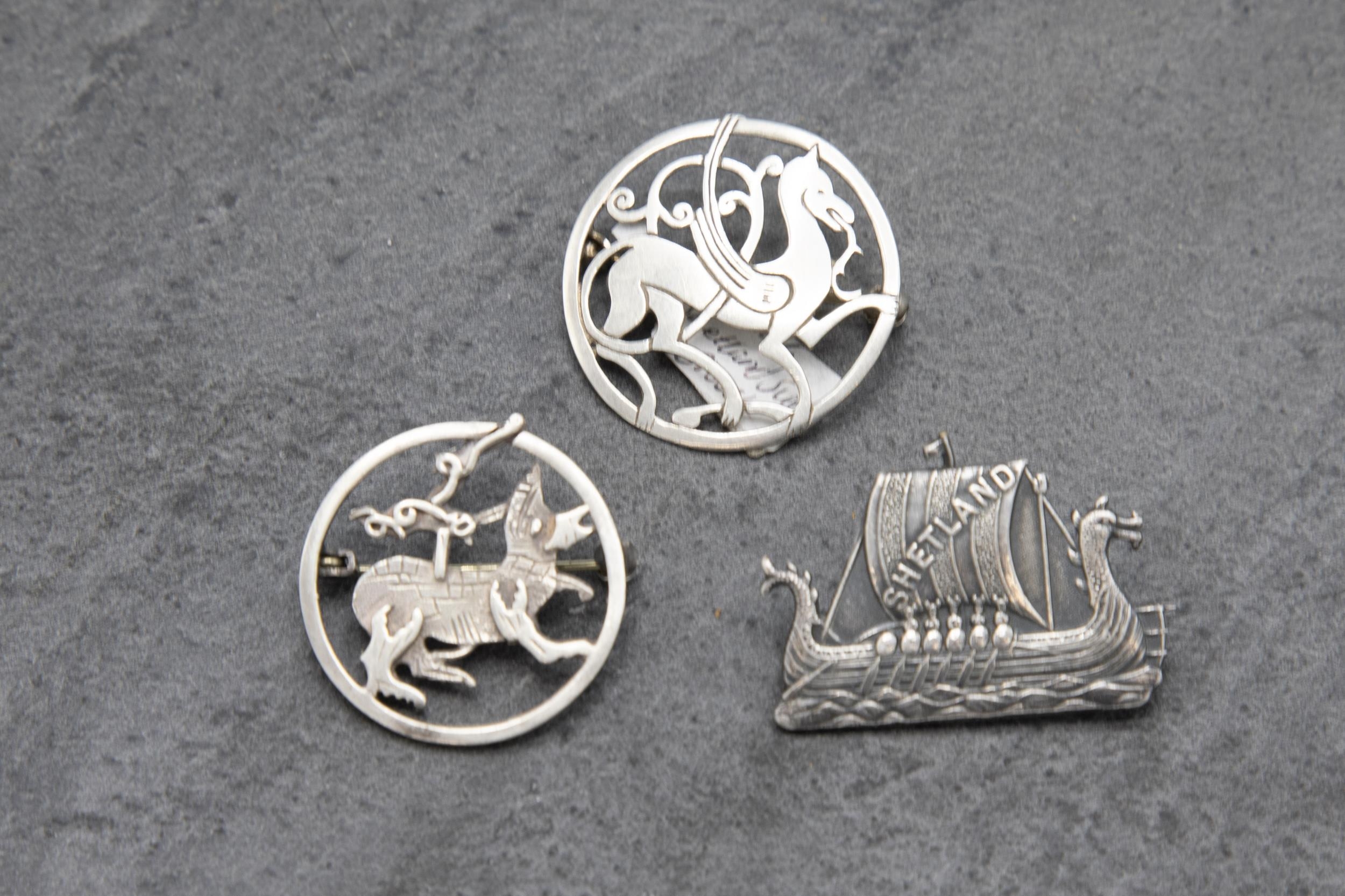 Two Scottish Ortak Maeshowe Dragon silver brooches, with a further Shetland longboat silver