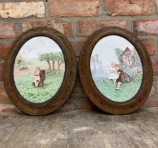 Pair of late 19th century hand painted porcelain oval panels of children in rural landscape, 28 x