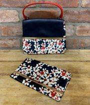 Carolina Herrera - leather and silk handbag with navy, red and floral design together with a