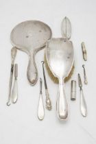 Mixed dressing lot of silver comprising brush and hand mirror, eight manicure tools and mother of