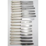 Good quality set of eight silver cannon handled table and dessert knives, the handle embossed with