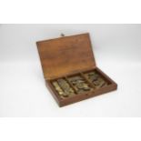 19th century mahogany box of brass bovine or agricultural animal tattoo letters and numbers, the box