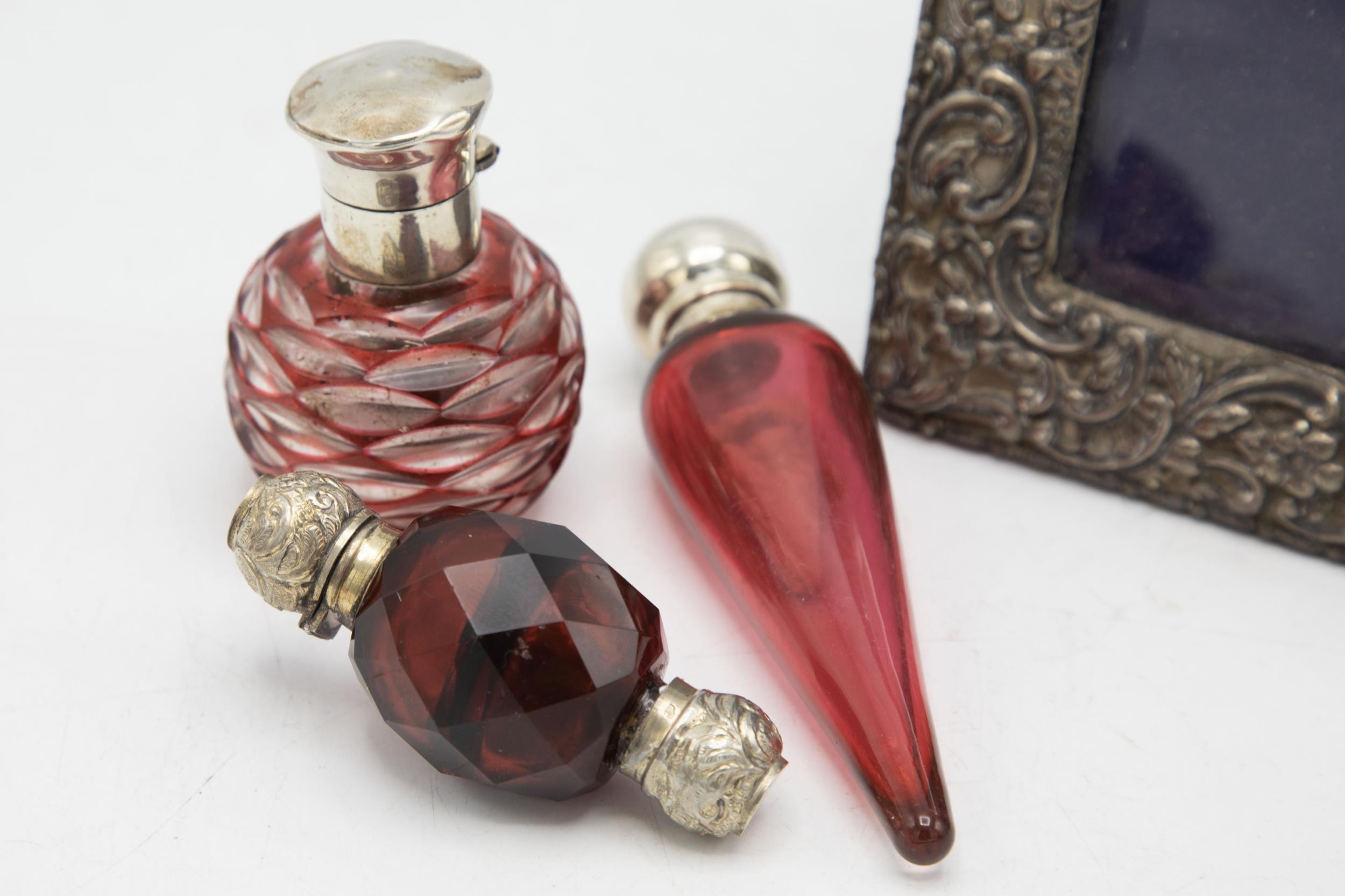 Victorian silver mounted cranberry glass teardrop scent bottle, 13cm long, with a further silver and - Image 2 of 3
