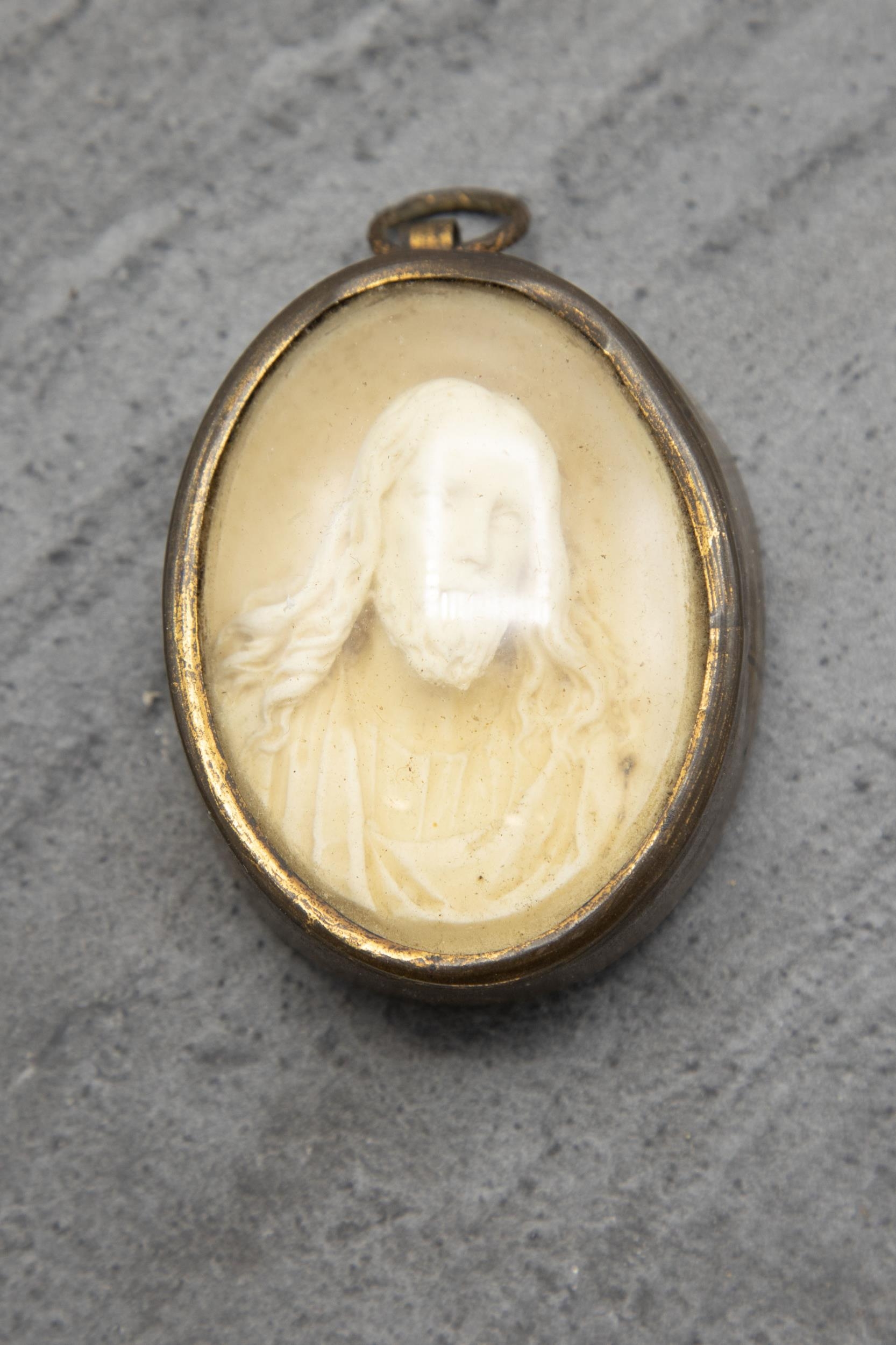 Grand Tour carved plaster pendant of Jesus Christ, held in original brass casing, 6.5cm x 5cm