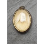 Grand Tour carved plaster pendant of Jesus Christ, held in original brass casing, 6.5cm x 5cm