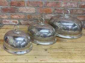 Expectational graduated set of three silver plated cloches or meat covers, each with cast handle and