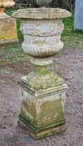Reconstituted stone Campana shaped garden urn with lobed bowl and flared egg and dart rim raised