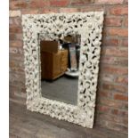 Indian painted wall mirror, frame with overlapping scrolled foliage, 122cm x 90cm