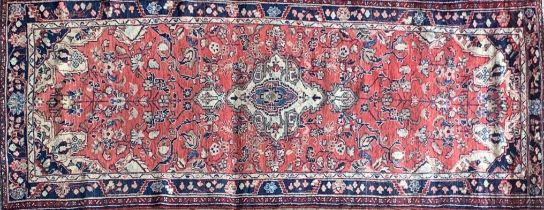 Good Persian Sarouk Mahal runner, traditional floral decoration on a washed red and blue ground, 320