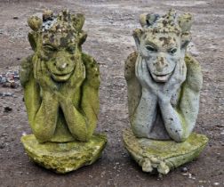 Pair of weathered reconstituted stone garden statues of winged gargoyles, H 61cm
