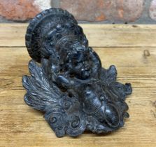 Early 18th century pewter cherub candlestick wall sconce, the cherub having a scrolled acanthus leaf