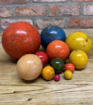 Set of twelve early hand carved Russian graduating spheres, rustic hand painted finish to each