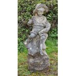 A weathered reconstituted stone garden water feature of a boy holding a fish seated on a rock, H