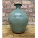 Jim Malone (1946) studio pottery vase, green ash glaze with incised fish decoration, stamped to