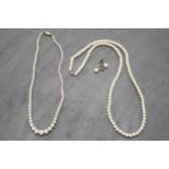 Pair of 9ct pearl earrings, with two pearl necklaces with 9ct clasps (3)