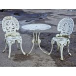 A painted cast metal three piece garden terrace set to include a table and two chairs with pierced