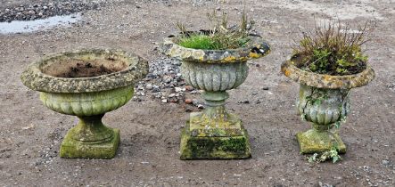 Three weathered reconstituted stone garden urns with lobed bowls and flared rims (3)