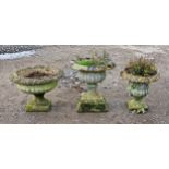 Three weathered reconstituted stone garden urns with lobed bowls and flared rims (3)