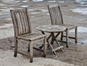 A pair of teak garden chairs with slatted seats and backs, H 63cm, together with a folding side