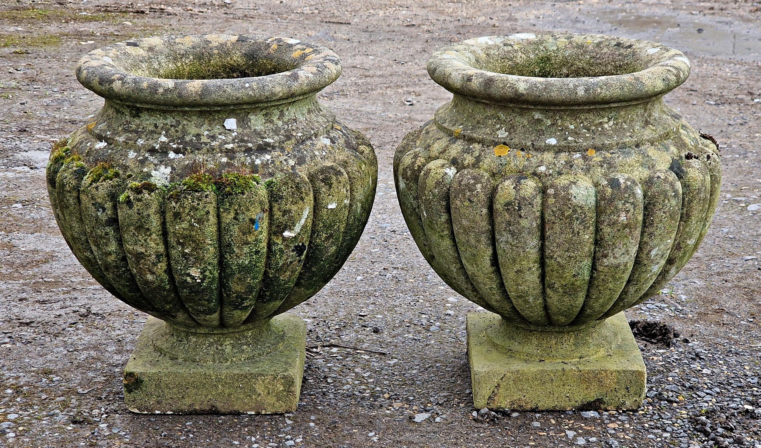 Pair of weathered reconstituted garden urns with lobed bowls and fixed socles, H 44cm x 20cm