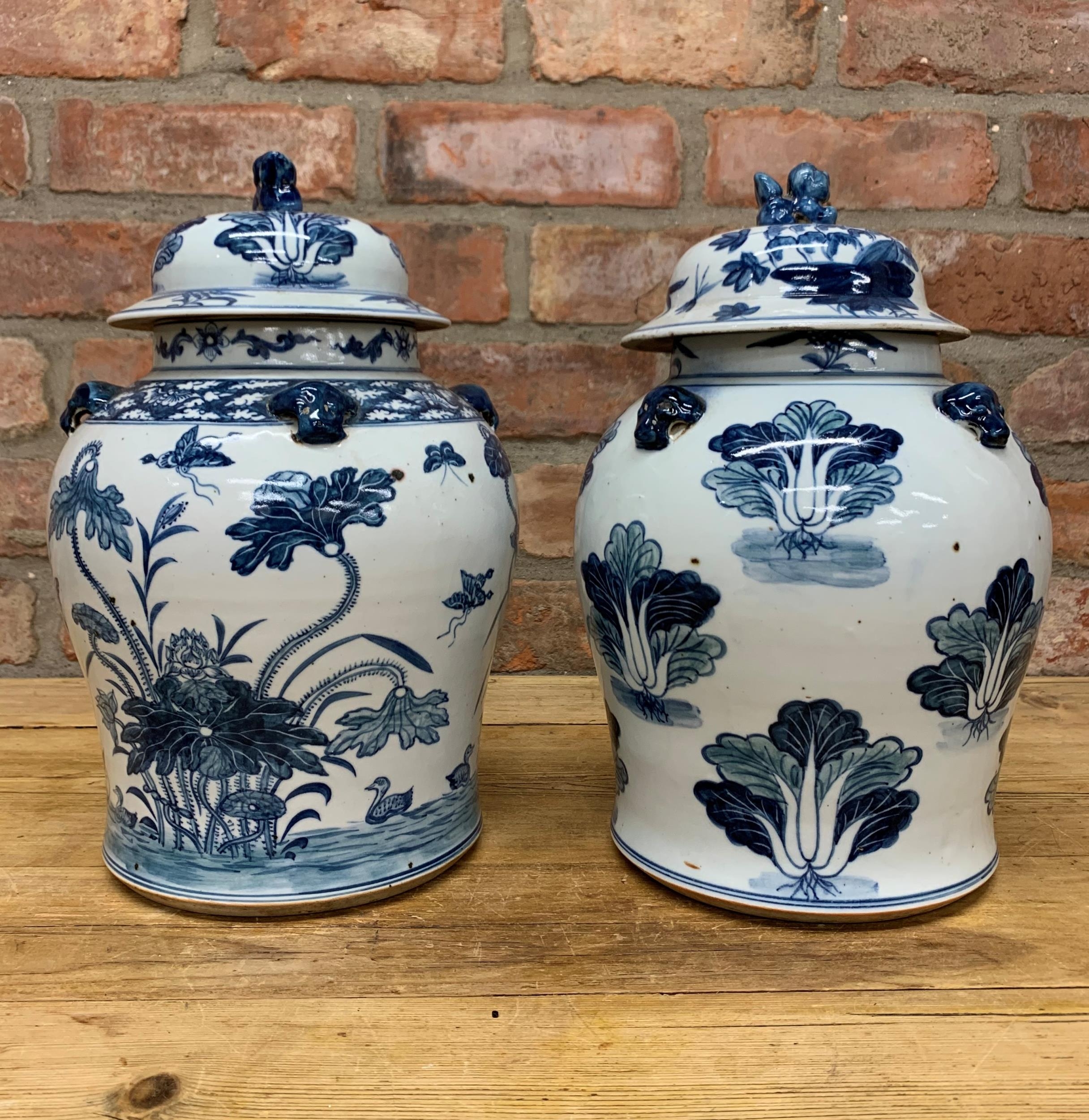 Matched pair of Chinese blue and white export porcelain lidded ginger jars, foo dog finial lid, H