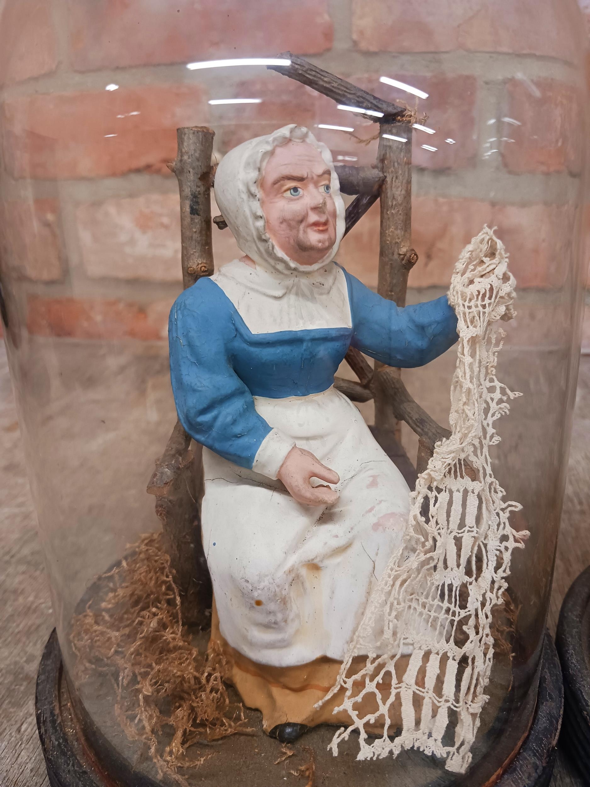 Pair of hand painted pottery figures of seated husband and seamstress wife held in original glass - Image 2 of 3