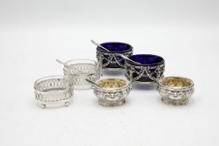 Three pairs of continental white metal salts with original glass liners and five spoons (11)