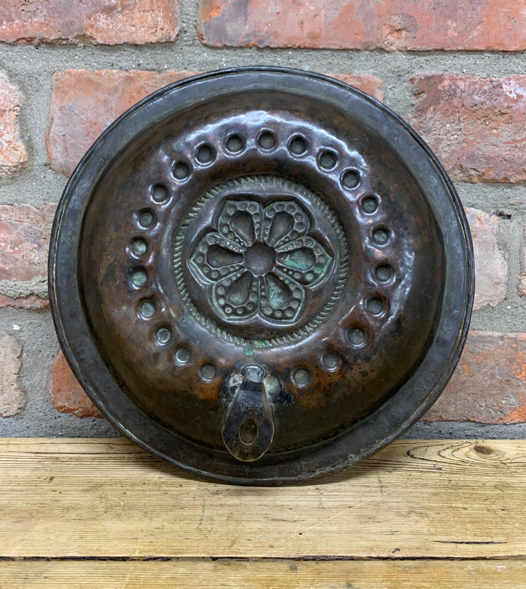 17th century hammered copper Alms dish with central floral design, D 27cm - Image 3 of 3