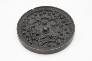 Early Tang Dynasty Chinese bronze mirror, decorated with a scrolled animals and birds amongst