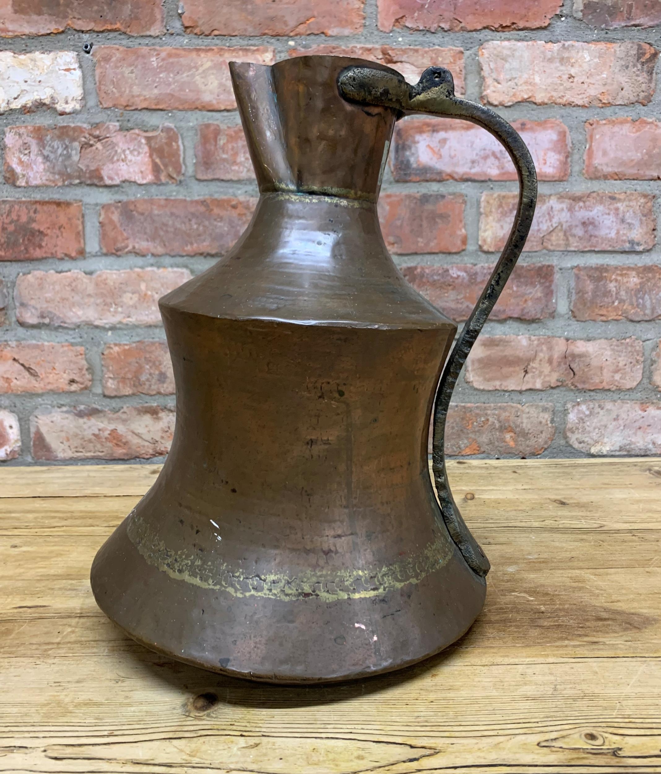 Large early Persian copper ewer with cast brass handle, 39cm high