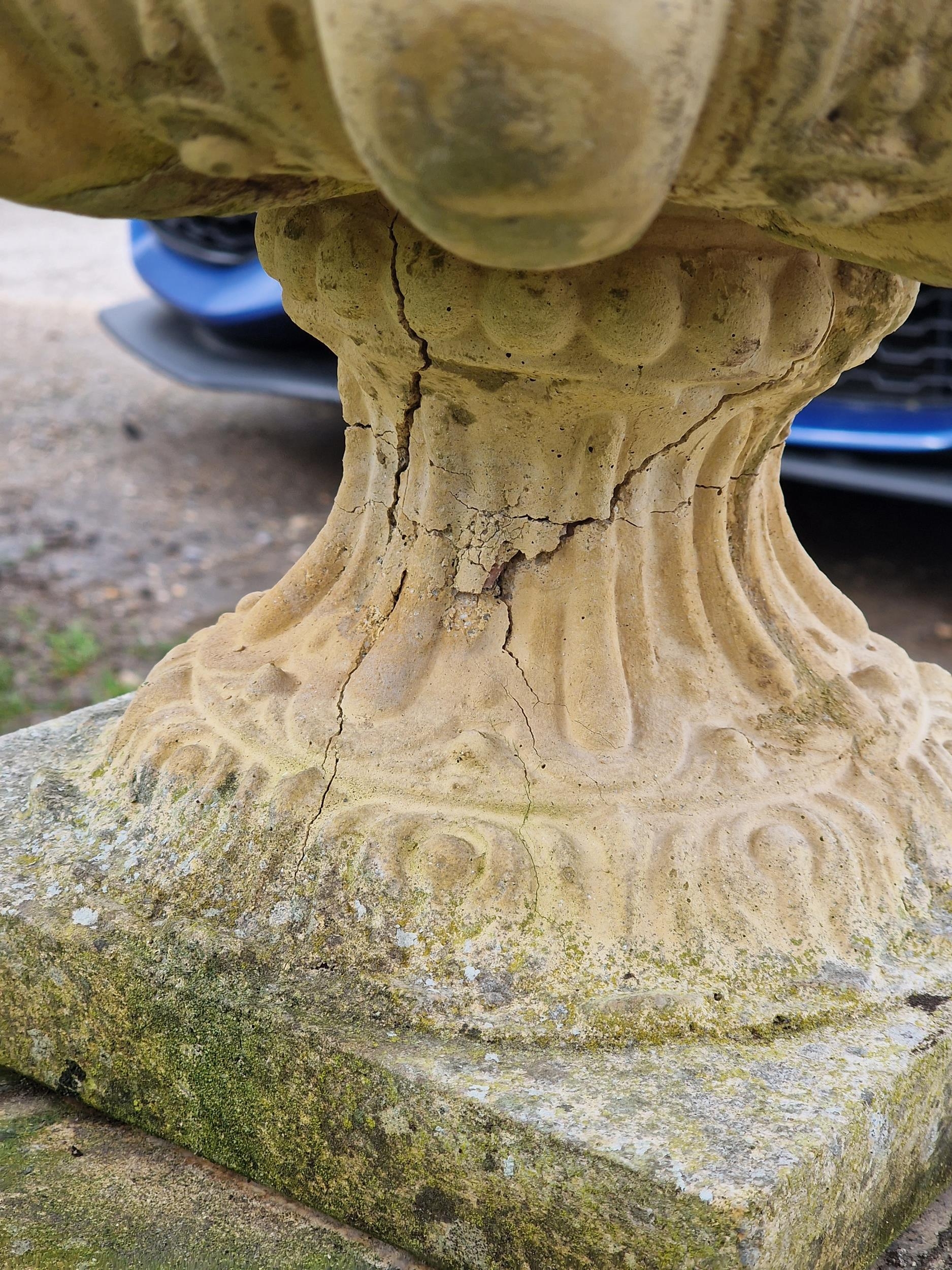 A pair of weathered reconstituted stone garden urns with lobed bowls raised on square cut pedestals, - Image 3 of 3