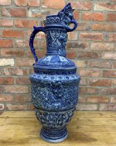 Very large Westerwald Rhineware exhibition blue and white ewer with ornate battlefield scene, H 86cm