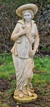 Weathered resin statue of a lady in a hat clutching a flower, H 125cm