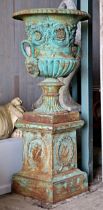 An impressive classical style cast iron Campana shaped garden urn with lobed bowl and twin mask loop