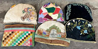 Collection of five vintage tea cosies including two blank ground examples with embroidered