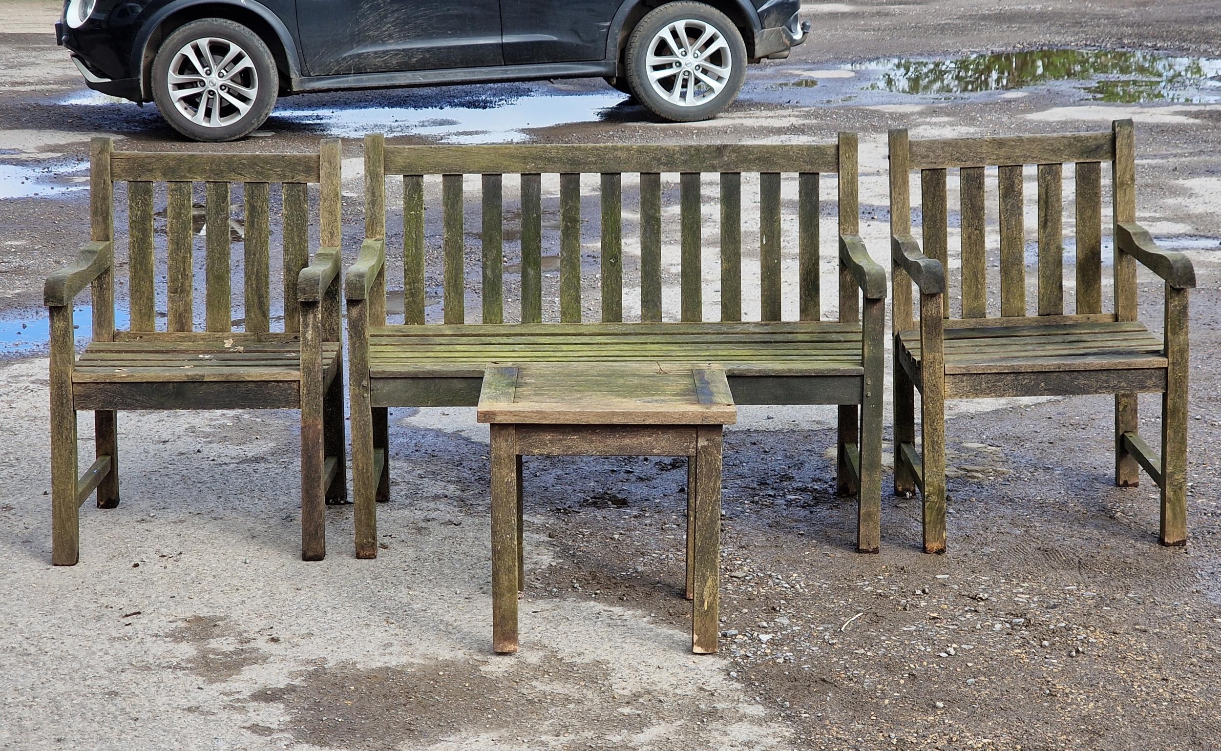 A weathered teak garden suite with slatted seats and backs to include two armchairs, a bench and a - Image 2 of 2