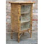 Victorian Aesthetic Movement bamboo and rattan side cabinet, the single glazed panel door