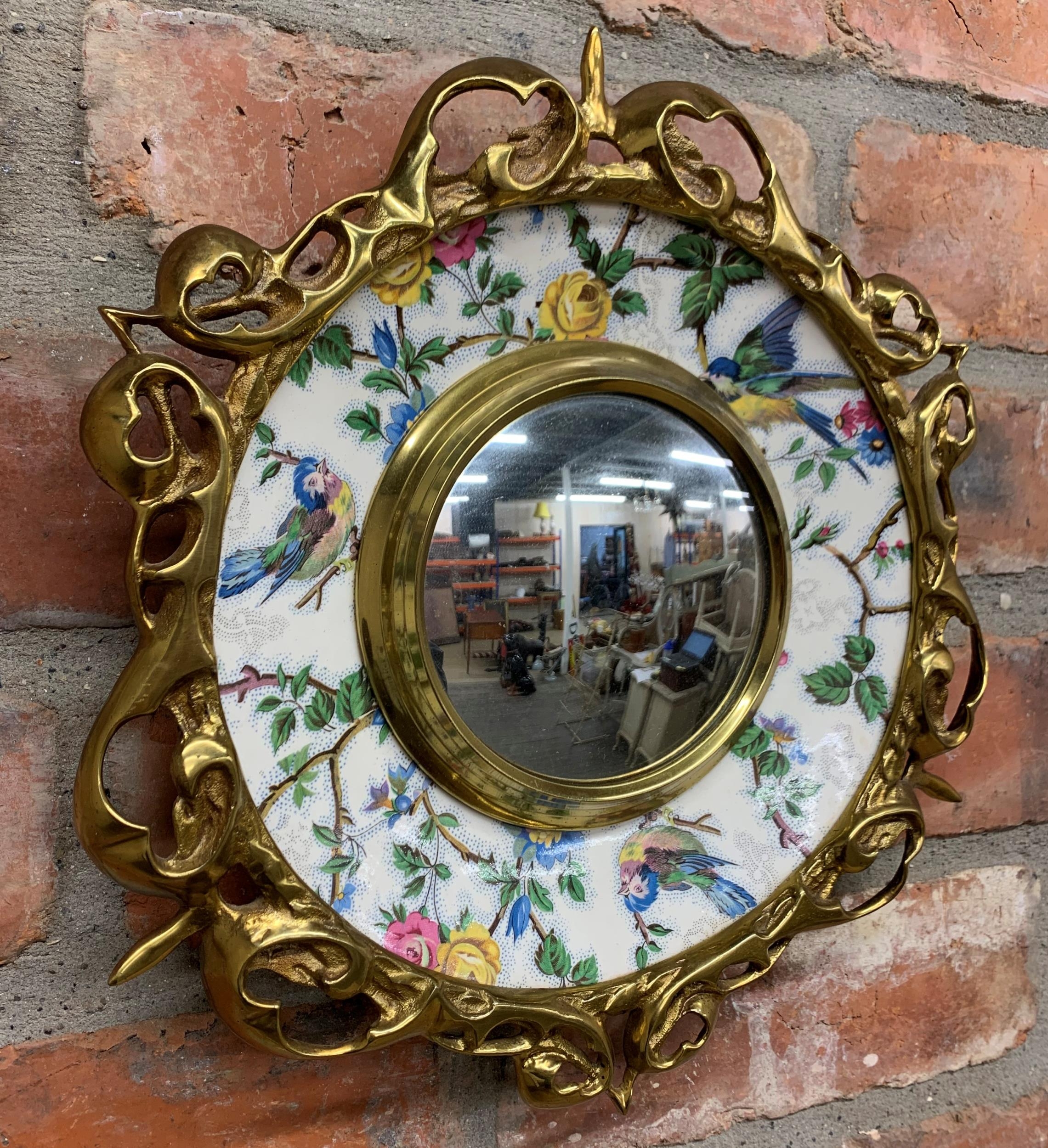 Clarice Cliff Art Deco convex mirror with floral and bird design ceramic surround held within