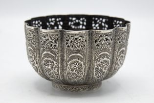 Indian white metal (untested) lobed pedestal bowl embossed with scroll foliage, 11cm diameter, 6oz