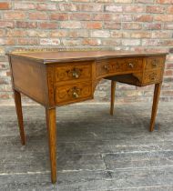 Edwardian Sheraton style satinwood reverse bow front desk or writing table, raised darted brass