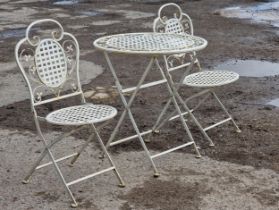 A painted metal three piece folding garden terrace set to include a table and two chairs with