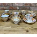 Assortment of antique hand painted peach floral themed cups, saucers and plates