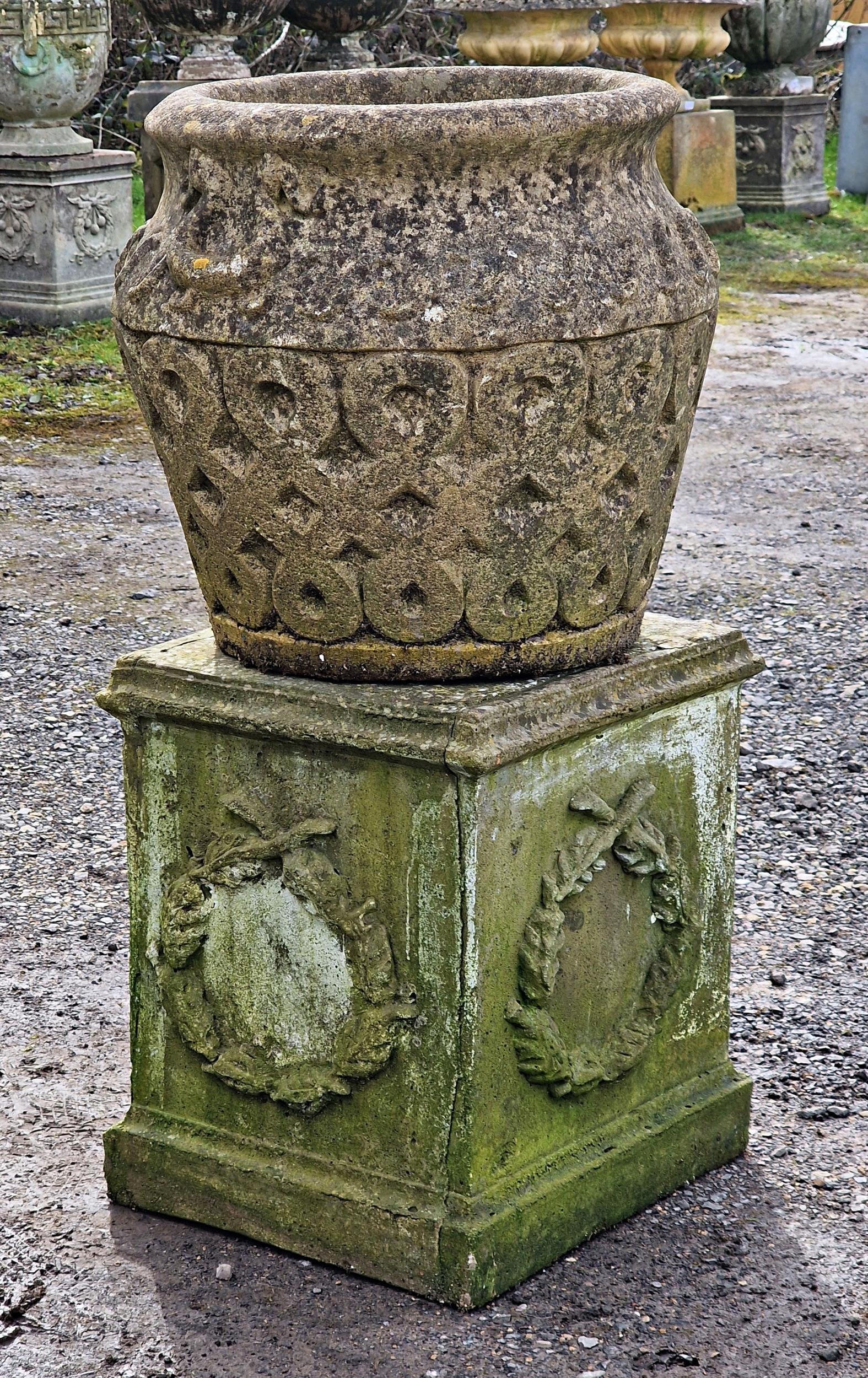 A weathered reconstituted stone garden planter with repeating lattice detail raised on a square - Image 2 of 3