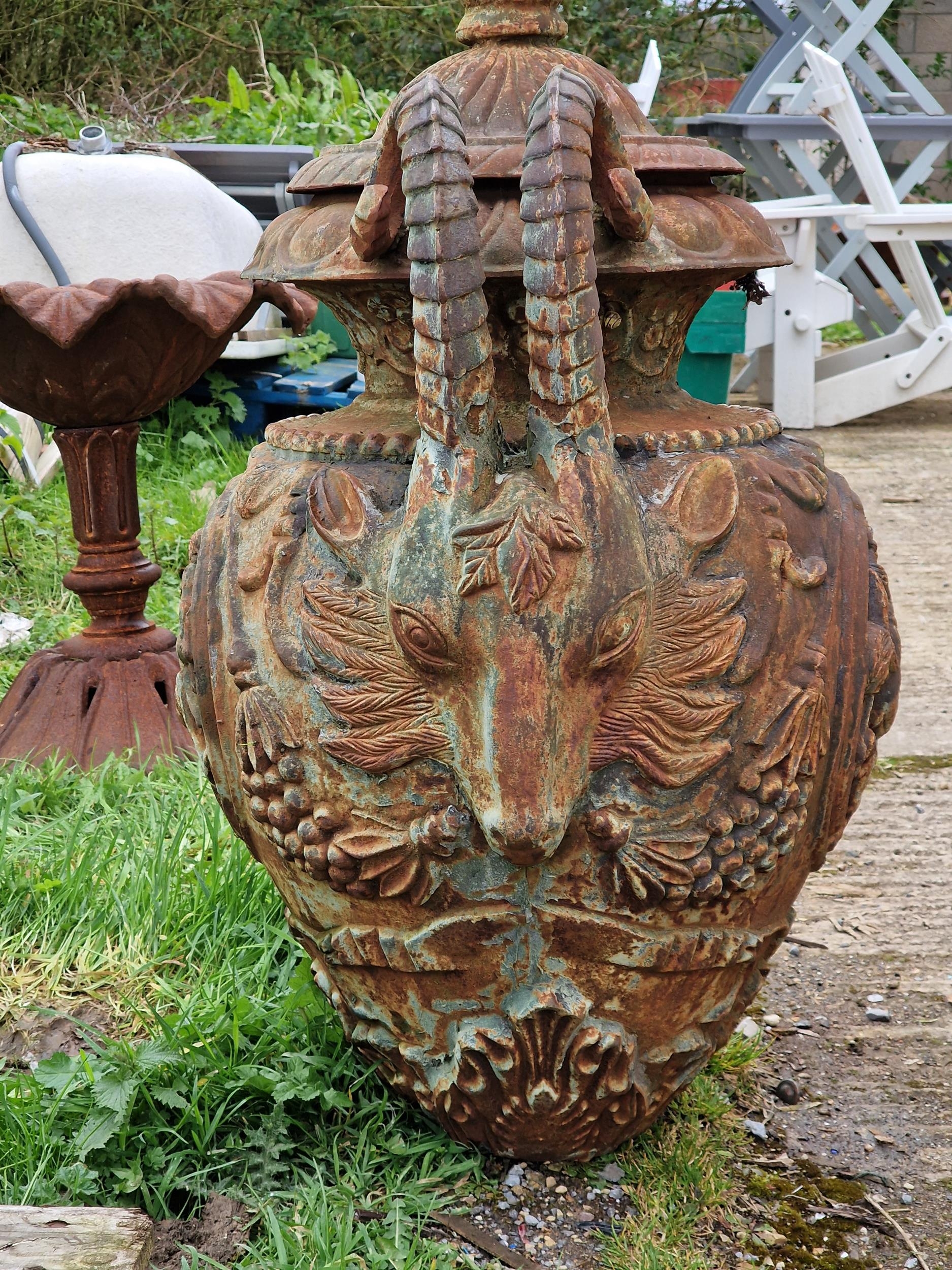A good quality ornate cast iron garden urn with rams head handles, pineapple finial and foliate - Image 2 of 3