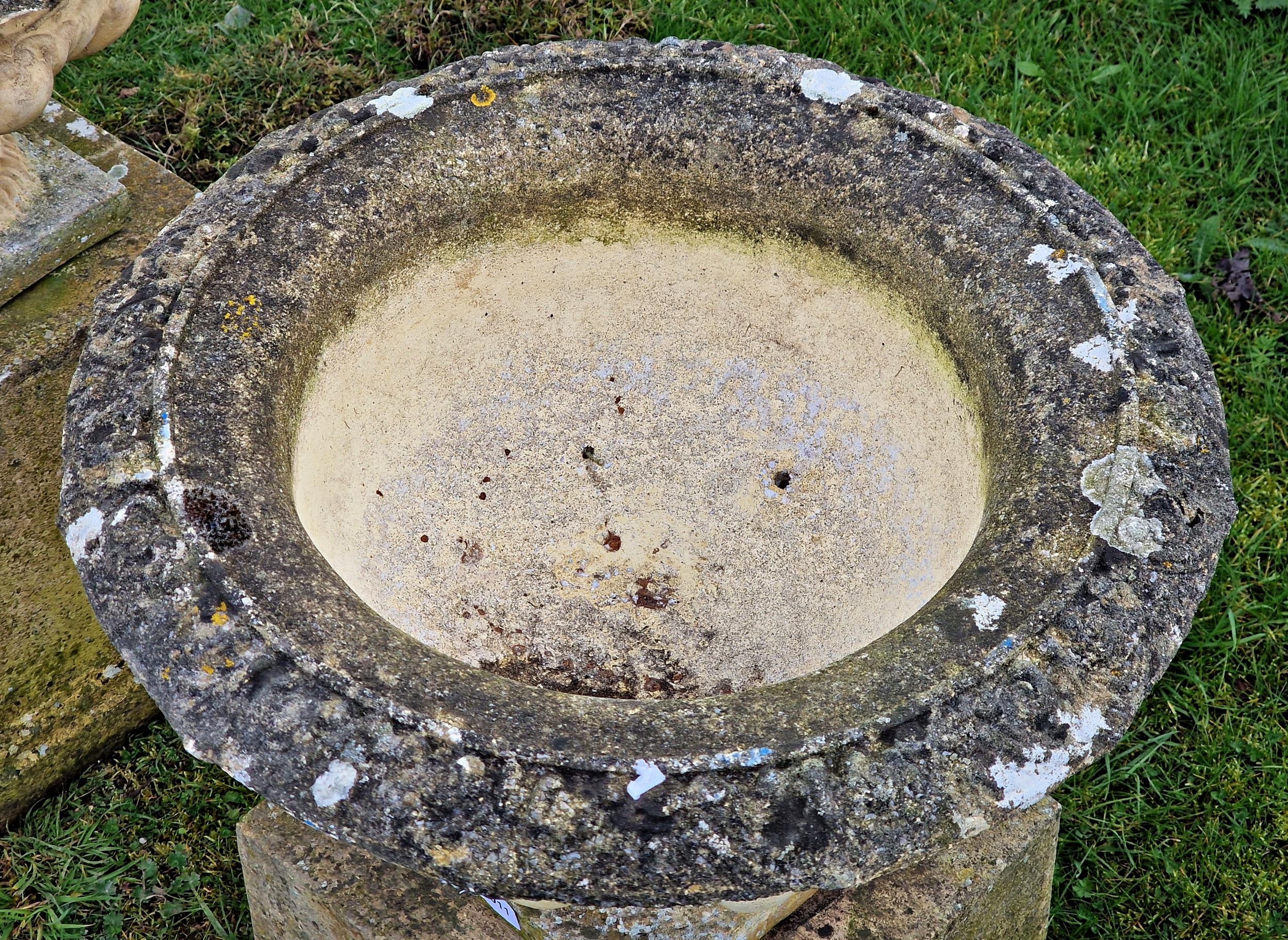 A pair of weathered reconstituted stone garden urns with lobed bowls raised on square cut pedestals, - Image 2 of 3