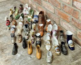 Collection of miniature ceramic and metal shoes of various sizes