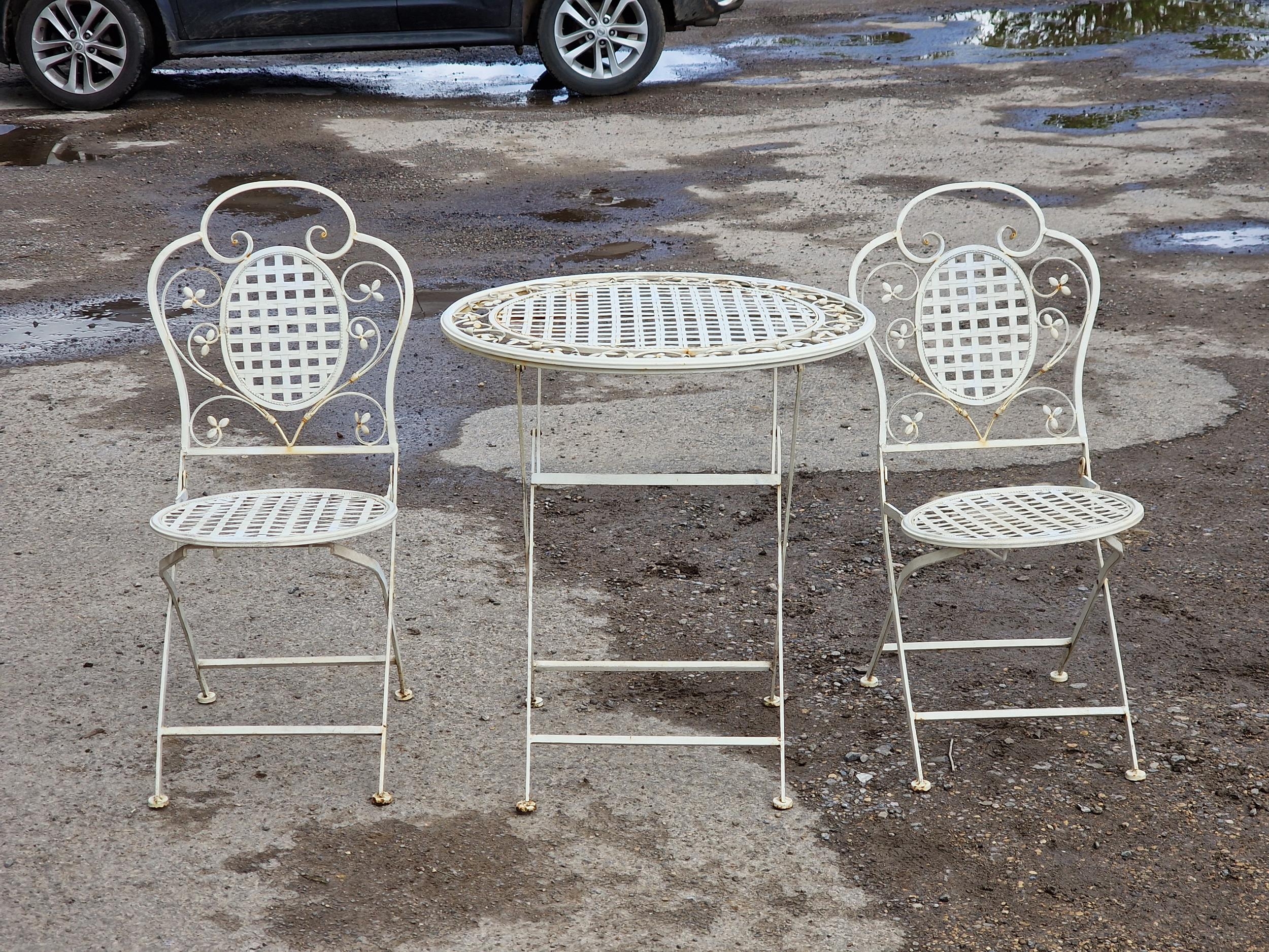 A painted metal three piece folding garden terrace set to include a table and two chairs with - Image 2 of 4