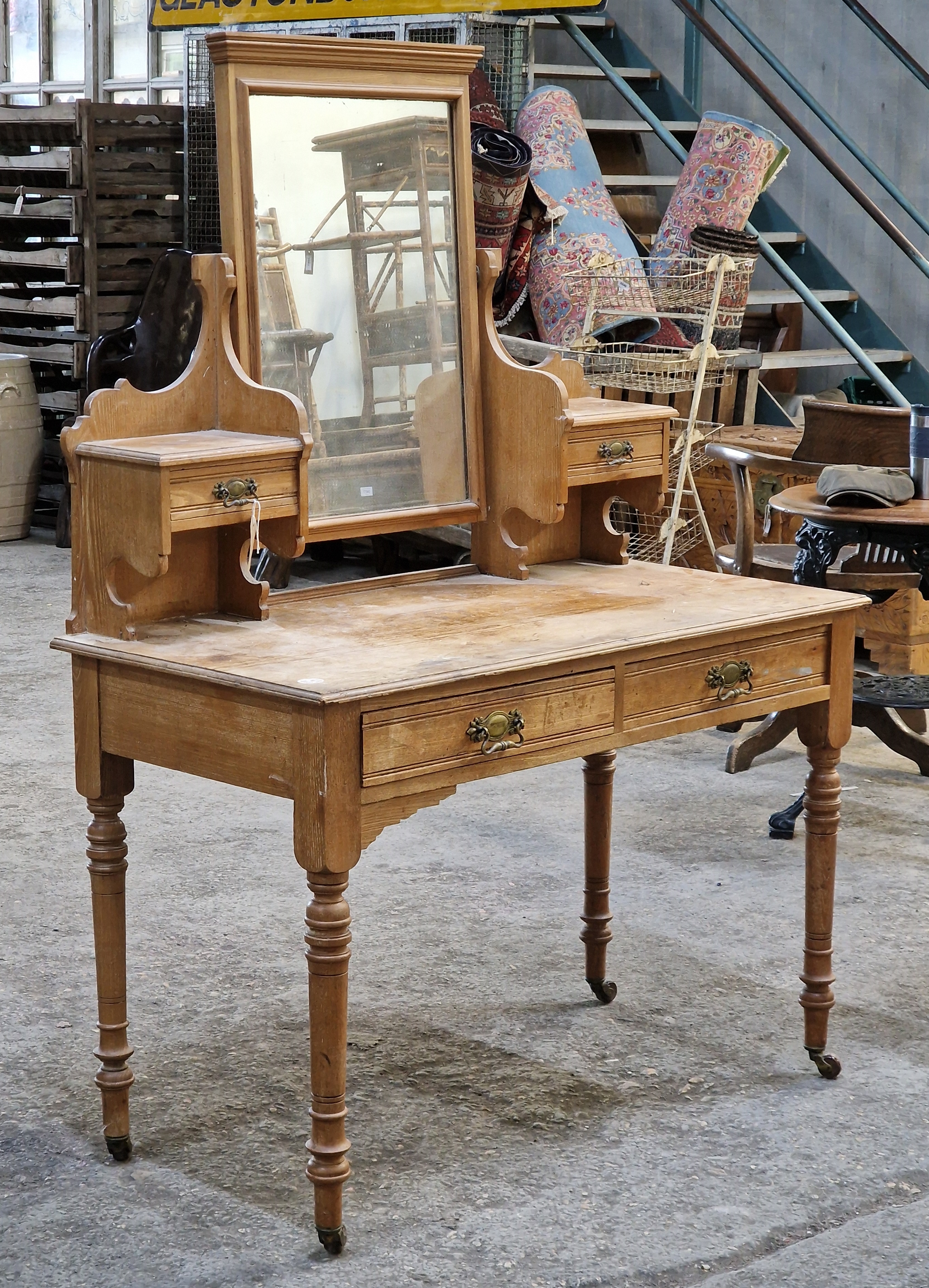 Victorian pine dressing table with turned legs raised on ceramic castors, H 121cm x W 107cm x D 54cm